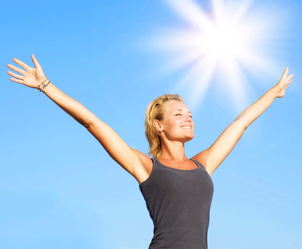 Woman with arms up smiling health and happy